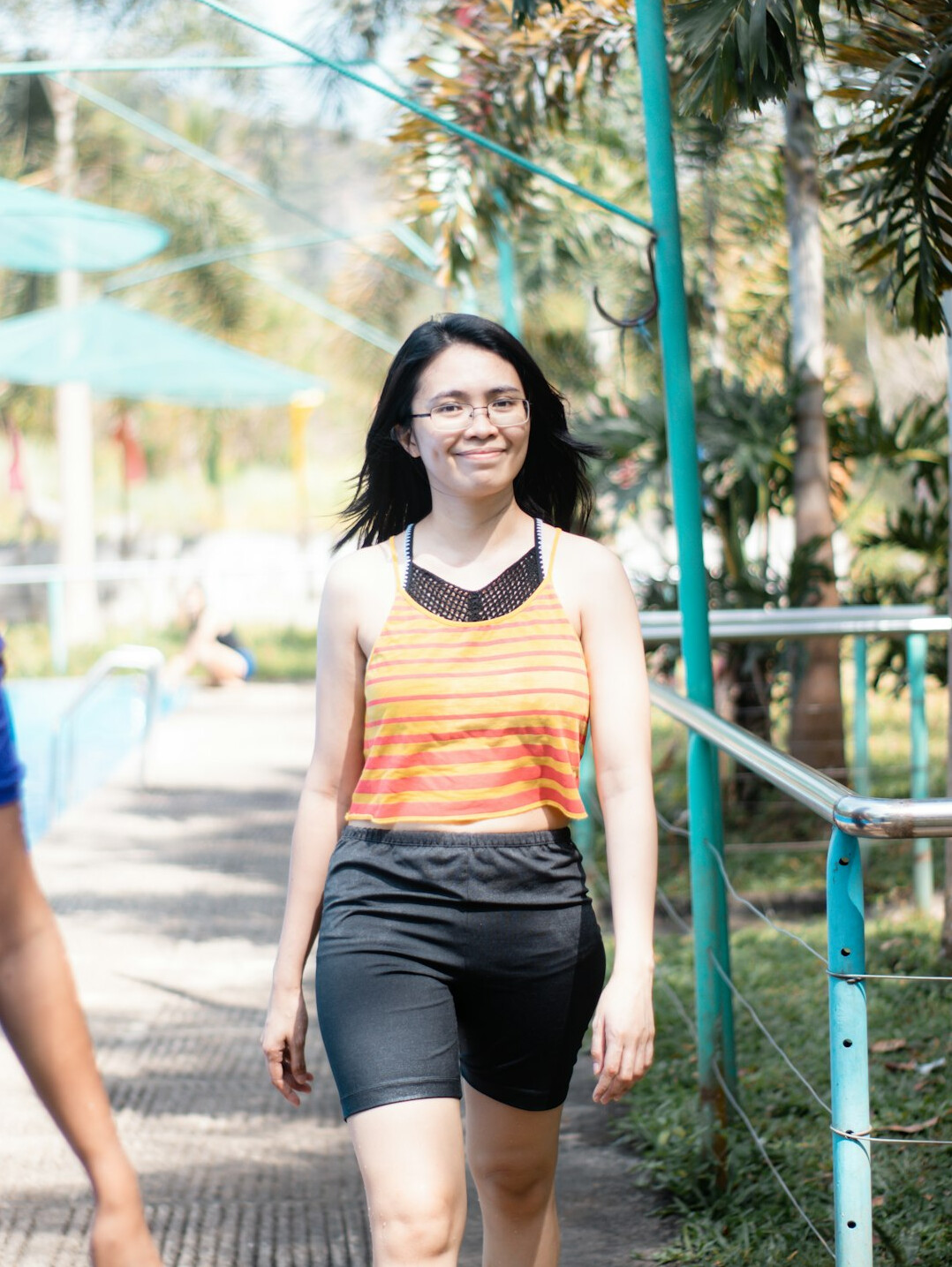 Singaporean wellness coach smiling in athletic wear